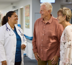 doctor talking to elderly couple