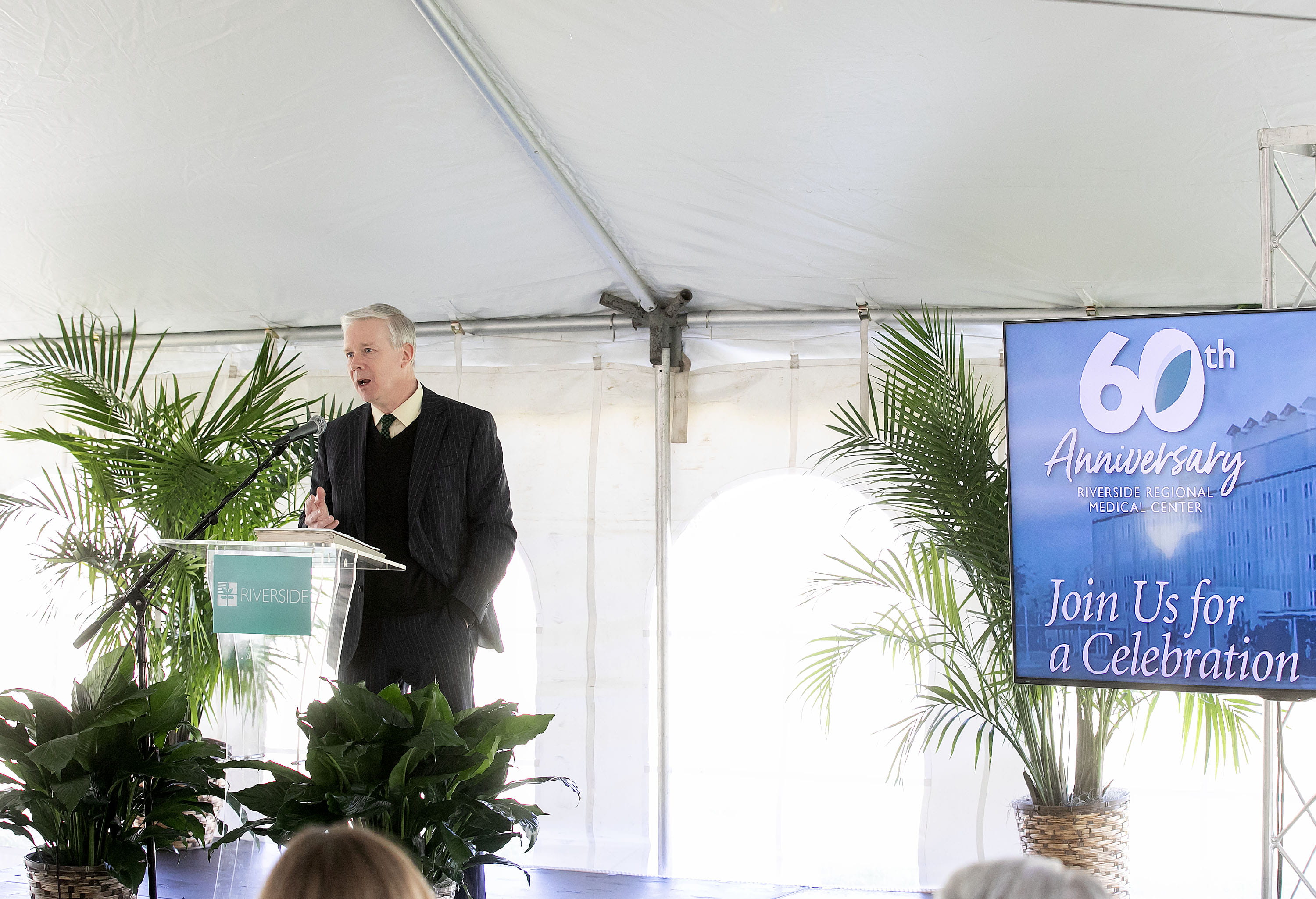 Mike Dacey speaking at a podium