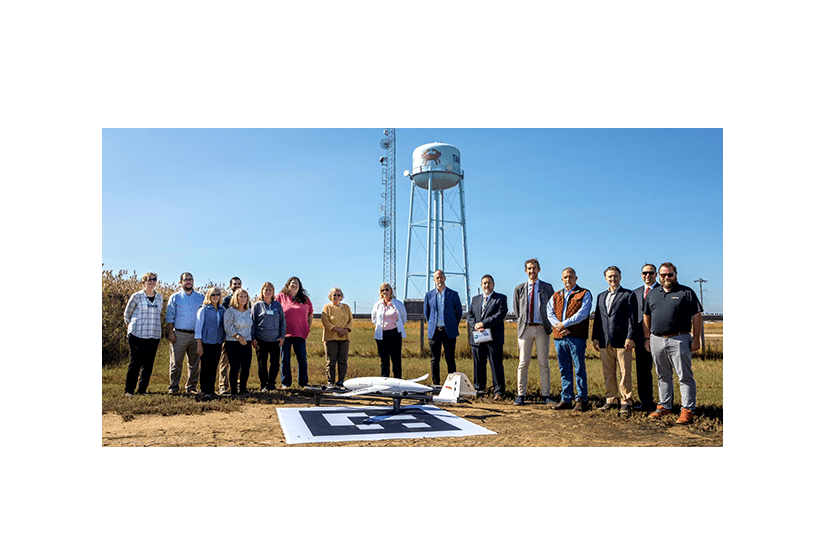 A team involved with Elevating Health Care Access displays one of the Kite B drones used in the project