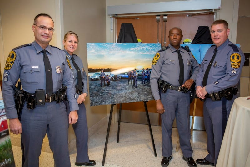 Police standing in front of exhibit art pieces