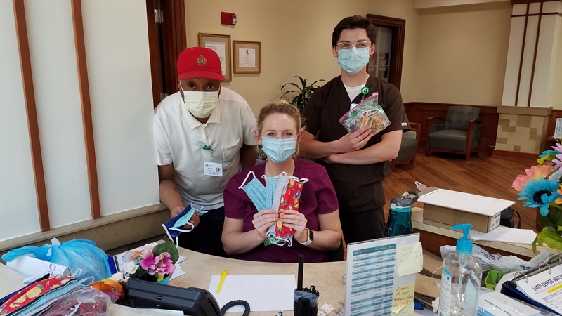 Healthcare workers holding donated face masks