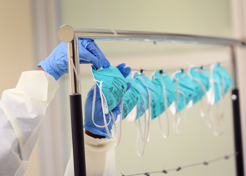 hospital staff hanging face masks to be sanitized