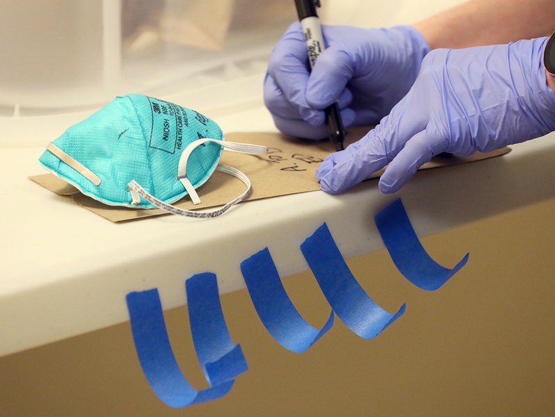 Hospital staff member labeling face mask