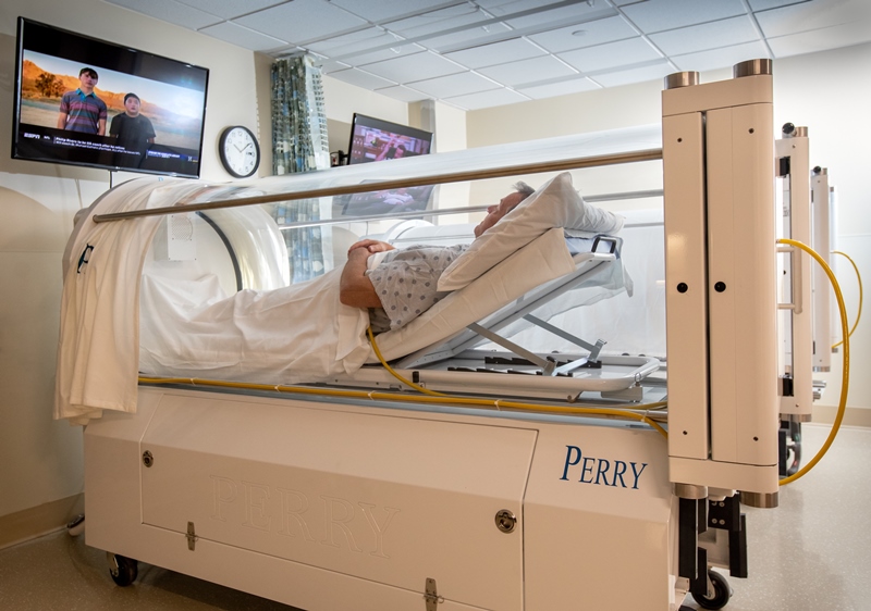 Patient laying in hyperbaric chamber
