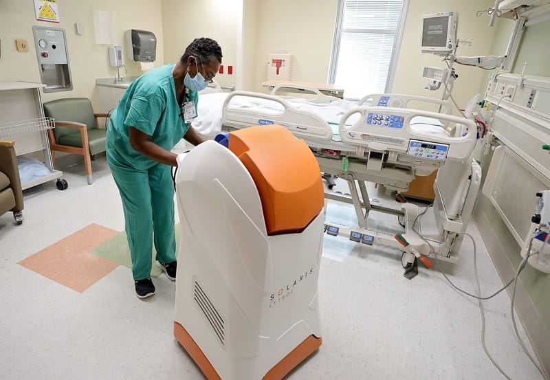 Staff member operating UV machine