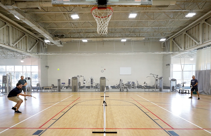 people playing pickleball on basketball court