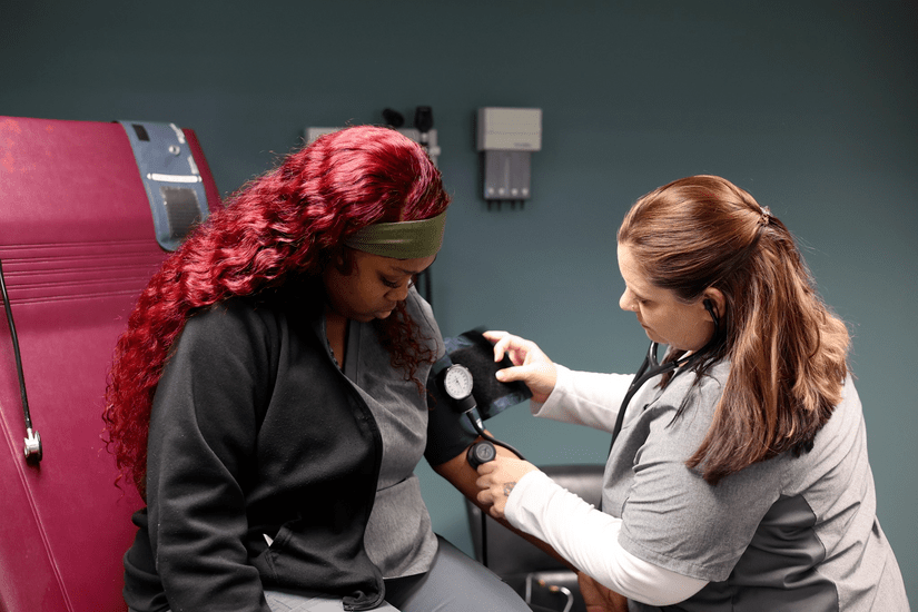 medical assistant attending to patient