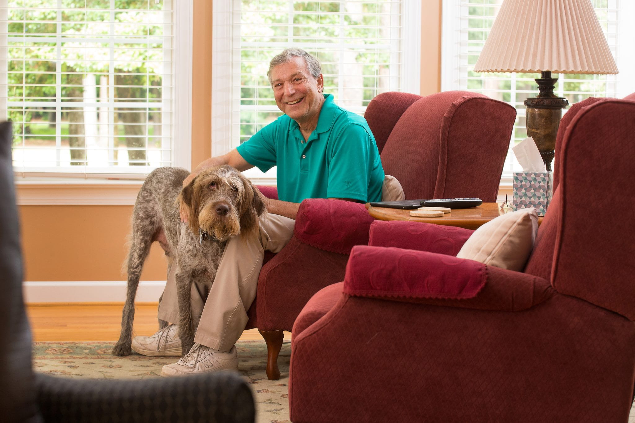 About Us Riverside Walter Reed Hospital Riverside Health System   Older Adult In Chair With Dog.ashx