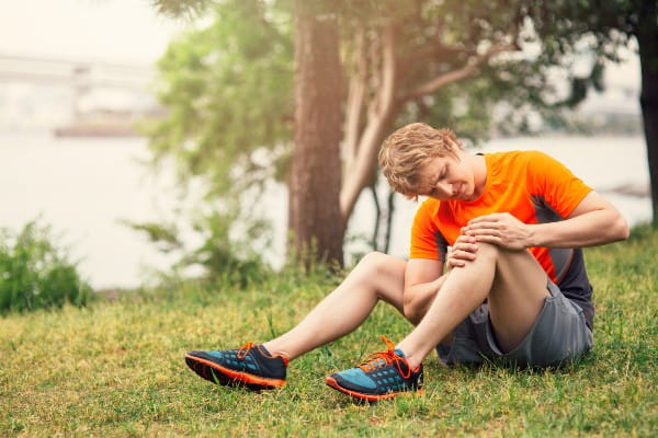 runner checking his knee