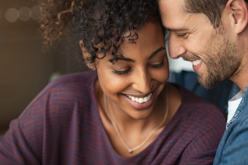 Multiethnic couple smiling embracing