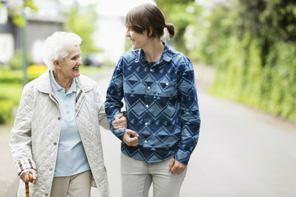 Older woman walking with younger woman